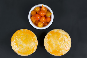 Traditional Brazilian mini chicken pies called empada with pepper pout in slate background seen from above