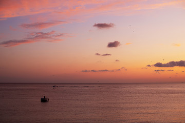 beautiful sunset, boat in water, clouds