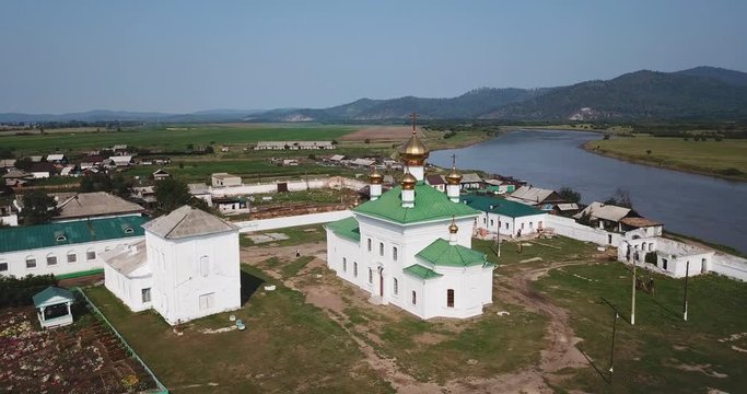 Holy Trinity Selenginsky Monastery flight above helicopter drone. Near Ulan-Ude best Russian nature panorama open space. Forward move cinematic. Sunny day.