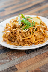 Pad Thai, vegan recipe made with rice noodles, vegetables and peanuts cooked on wok.