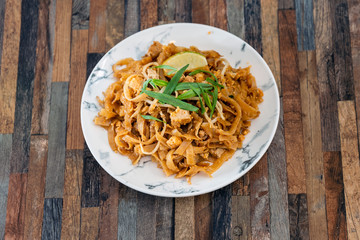 Pad Thai, vegan recipe made with rice noodles, vegetables and peanuts cooked on wok.
