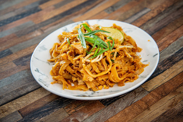 Pad Thai, vegan recipe made with rice noodles, vegetables and peanuts cooked on wok.