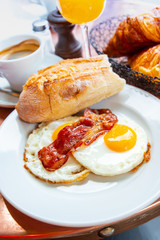 Breakfast with coffee and croissants on table