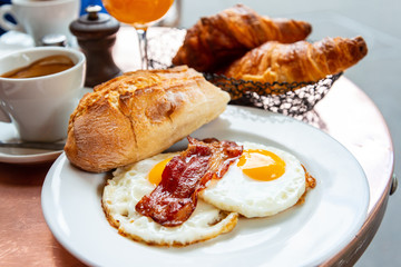 Breakfast with coffee and croissants on table