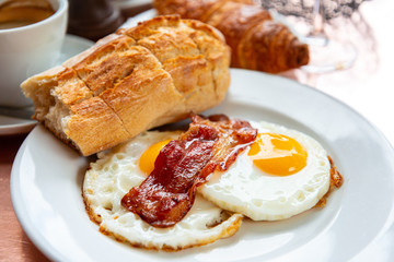 Breakfast with coffee and croissants on table
