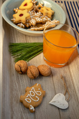 Christmas breakfast on wooden tray, fresh orange juice gingergread, shortcrust pastry cookies and pour feliciter pig 2020