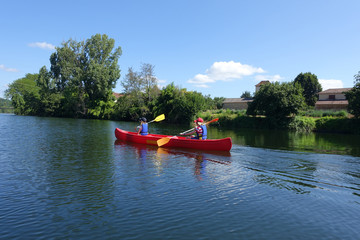 Two children canoing on the River lot in the Aquitaine region of France