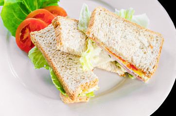 Fototapeta na wymiar Sandwich with ham tomato and egg with vegetable.