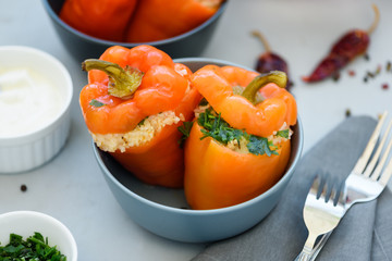 Colorful stuffed peppers on gray wooden background. Selective focus. Healthy food concept