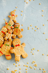 Christmas pattern of biscuits gingerbread man cookies on light blue background top view.Festive food.Christmas and New Year traditions concept
