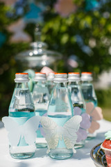 sparkling water in the same bottles for guests at a party
