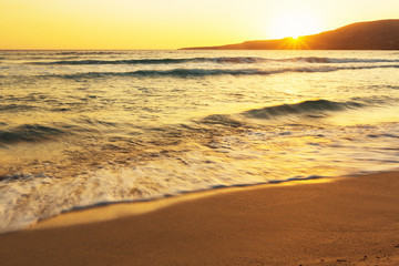 Fototapeta na wymiar Sunset on the Simos beach without tourists on the island of Elafonisos, Laсonia, Greece