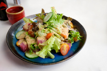 Delicious Garden salad with creamy dressing in plate on table