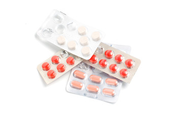 Medicine pills in blister, drug tablets isolated on white background. Pharmacy and medication.
