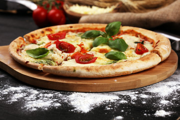 vegetarian italian Pizza with tomatoes, mozzarella cheese  and basil. Delicious italian pizza