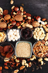 Composition with dried fruits and assorted healthy nuts on rustic background