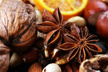 Composition with dried fruits and assorted healthy nuts on rustic background for christmas