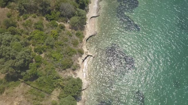 The aerial drone shot of sea water and mainland in Kalamos island, Greece, Europe.