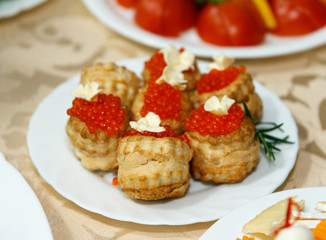 Buns with red caviar and butter in a plate