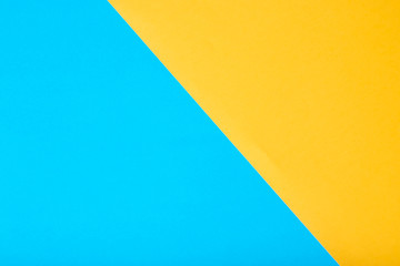 Yellow and blue two tone color paper background.