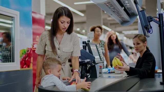 Mother and her child buying goods in a grocery store