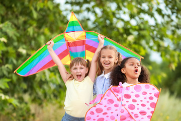 Little girls flying kites outdoors