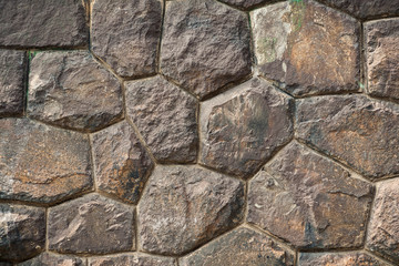 art background of large brown stone boulders in an ancient wall with high-precision masonry face to face for the original historical project or artistic design or decoration
