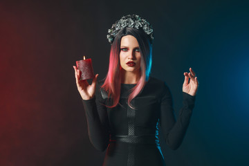 Obraz premium Beautiful woman dressed for Halloween on dark background