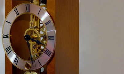 Closeup of old fashioned clock with roman letters and mechanism       