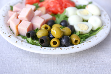 Plate with tasty fresh salad on table, closeup