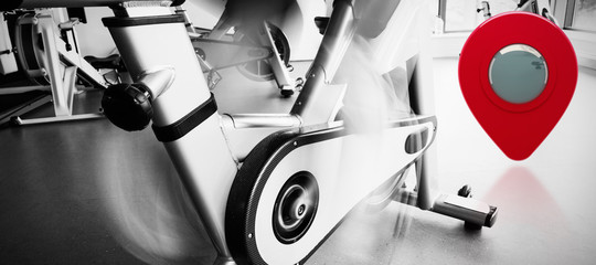 Composite image of low section of a determined woman working out at spinning class - Powered by Adobe
