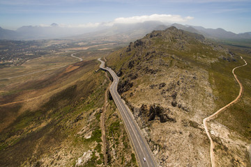 An aerial view over Sir Lowry's Pass, in a North westerly direction. towards Cape Town, with the Helderberg mountain range in the background, and Somerset West and Gordon's Bay in the foreground.