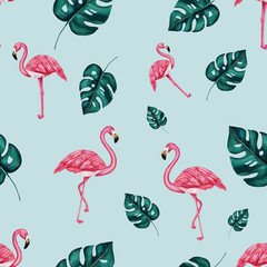 Flamingos and tropical monstera leaves on the soft blue seamless background