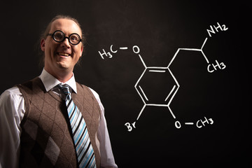 Professor presenting handdrawn chemical formula of Dimethoxybromoamphetamine dob