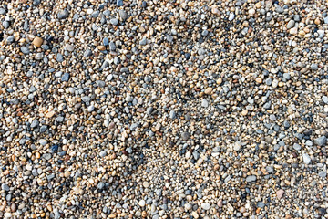 Natural peeble stone, fine gravel, shingle abstract texture background pattern top view copy sapce