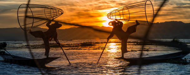 Burmese Fishermen posing with conical nets at sunset, Inle Lake in the Nyaungshwe Township part of Shan Hills in Myanmar Burma