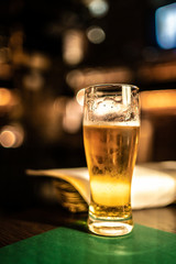 cold beer glass on bar or pub desk