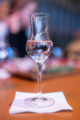 Shot glasses of vodka on a wooden table, addiction to alcohol.