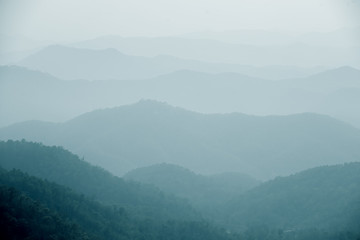 Naklejka premium Foggy Hills Background Samoeng Forest near Chiang Mai