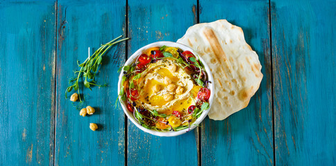 Hummus with olive oil, sprouts and tomatoes - 288178134