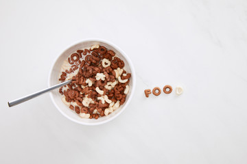 top view of cereal food inscription near bowl on marble surface