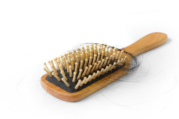 Isolated wooden brush with hair on white background