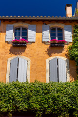 Arles. Facades of old houses and windows with shutters.