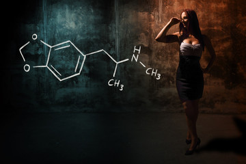 Sexy girl or secretary or female student presenting handdrawn chemical formula o MDMA ecstasy