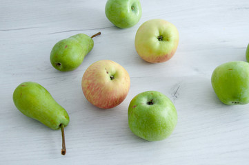 Fruits on a gray, wooden table. Pears, apples, banana close-up.