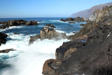 Fototapeta na wymiar Water rushing over rocks in the ocean in Tenerife, Spain