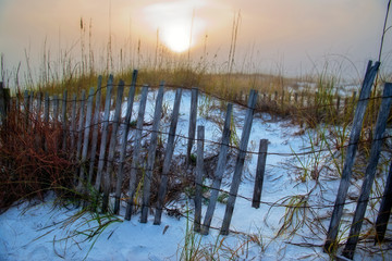 Fence and White Sand at Sunset