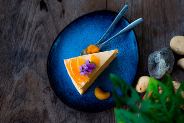  Orange flavored cake in a blue plate and spoon