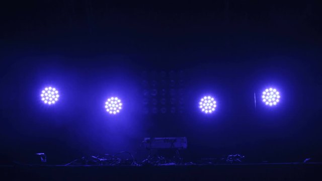 DJ Desk Pult in Stage disco hall. Disco Lights and smoke.