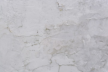 Texture of an old and cracked white wall